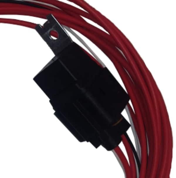 Close-up of a black electrical connector attached to several coiled red wires, with a metal mounting bracket visible at the top.