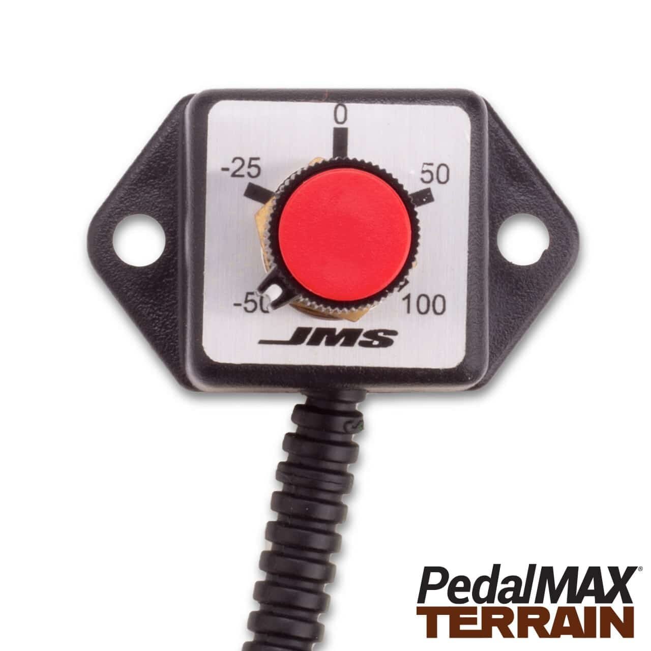 Close-up of a PedalMAX Terrain device by JMS with a red adjustment knob and a labeled dial ranging from -50 to 100. The device has a coiled cable attached to the bottom.