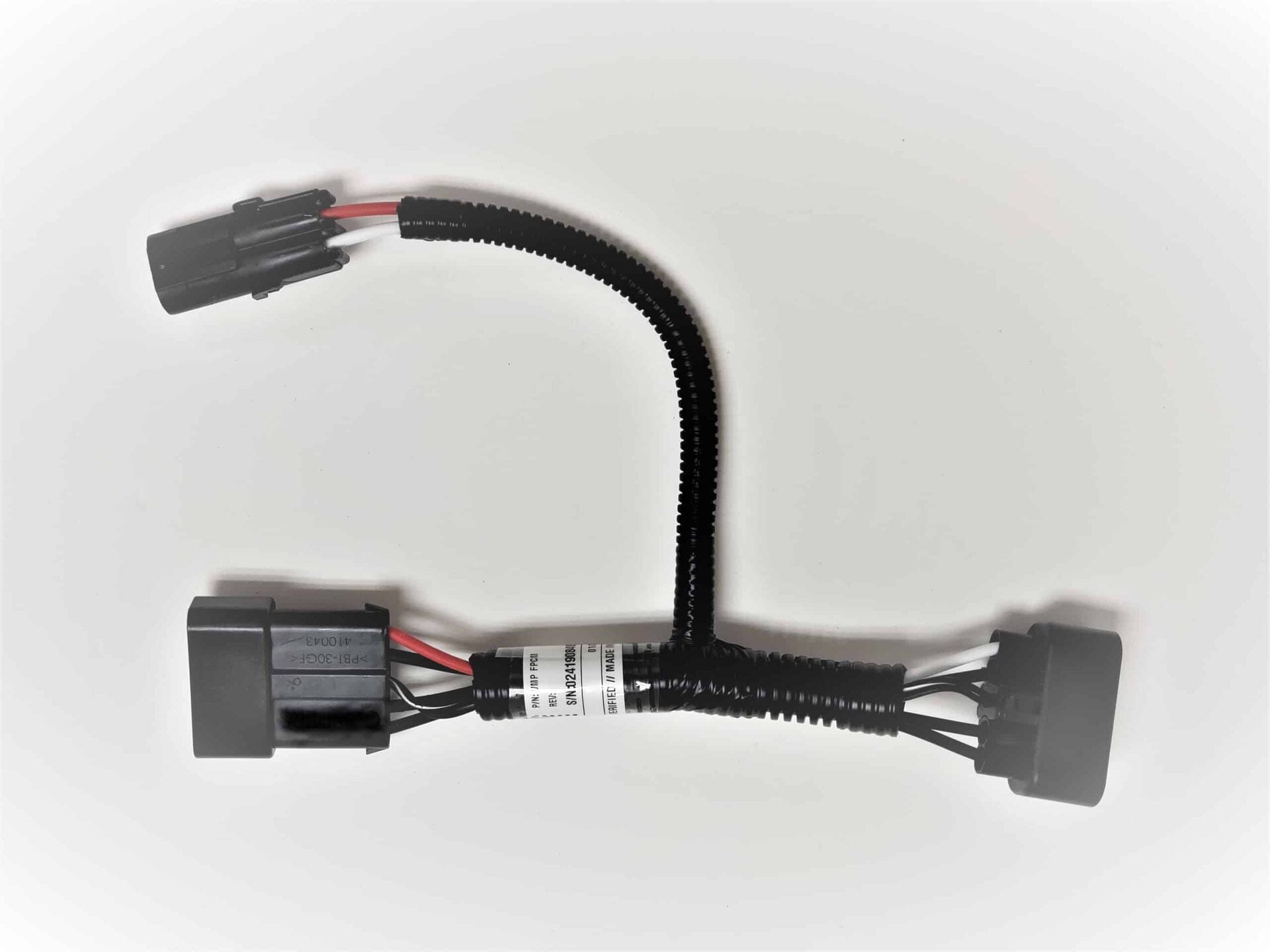 A black electrical wiring harness with three connectors and a flexible, corrugated protective sleeve, laid out on a white background.
