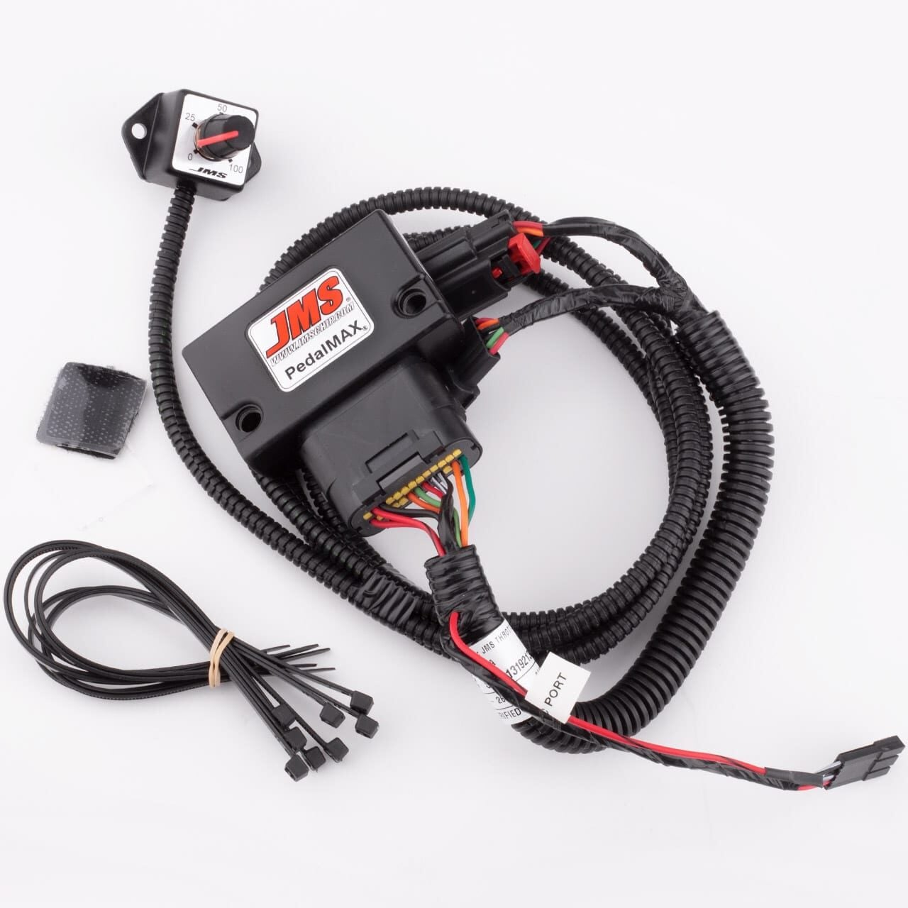 JMS PedalMAX electronic throttle control module kit with wiring harness, adjustment dial, zip ties, and adhesive pad, displayed on a white background.